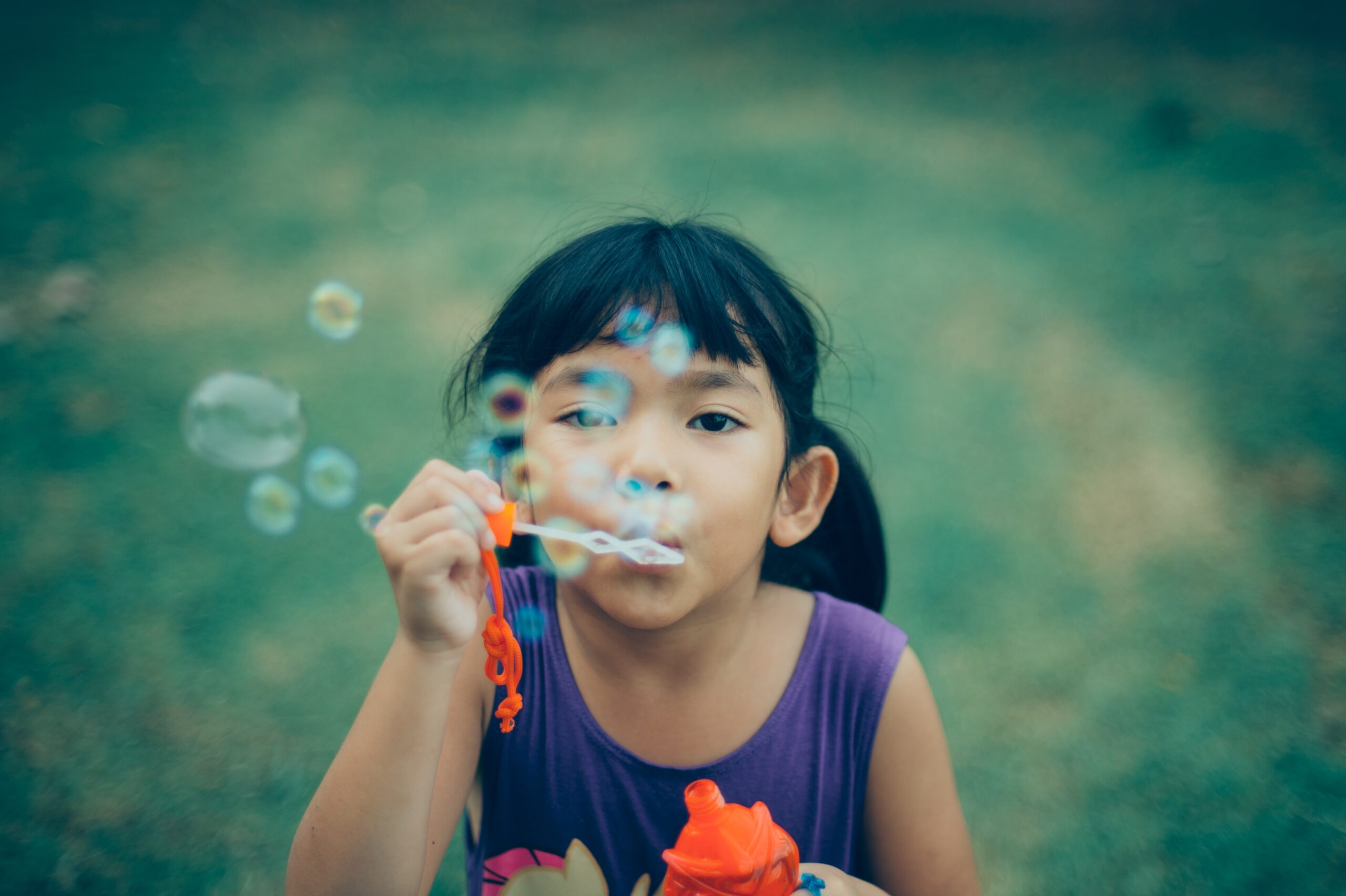 girl blowing bubbles summertime activities