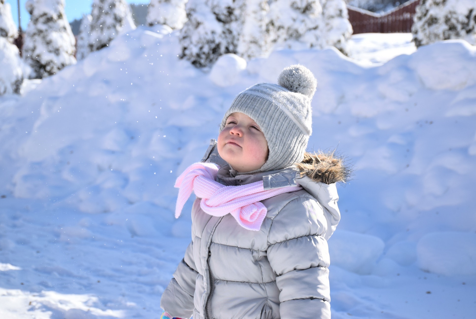 toddler in winter clothes in snow guide to winter break