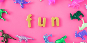 pink background with FUN spelled out surrounded by toys fun indoor activities