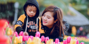 mother and son in field of spring flowers spring cleaning with kids