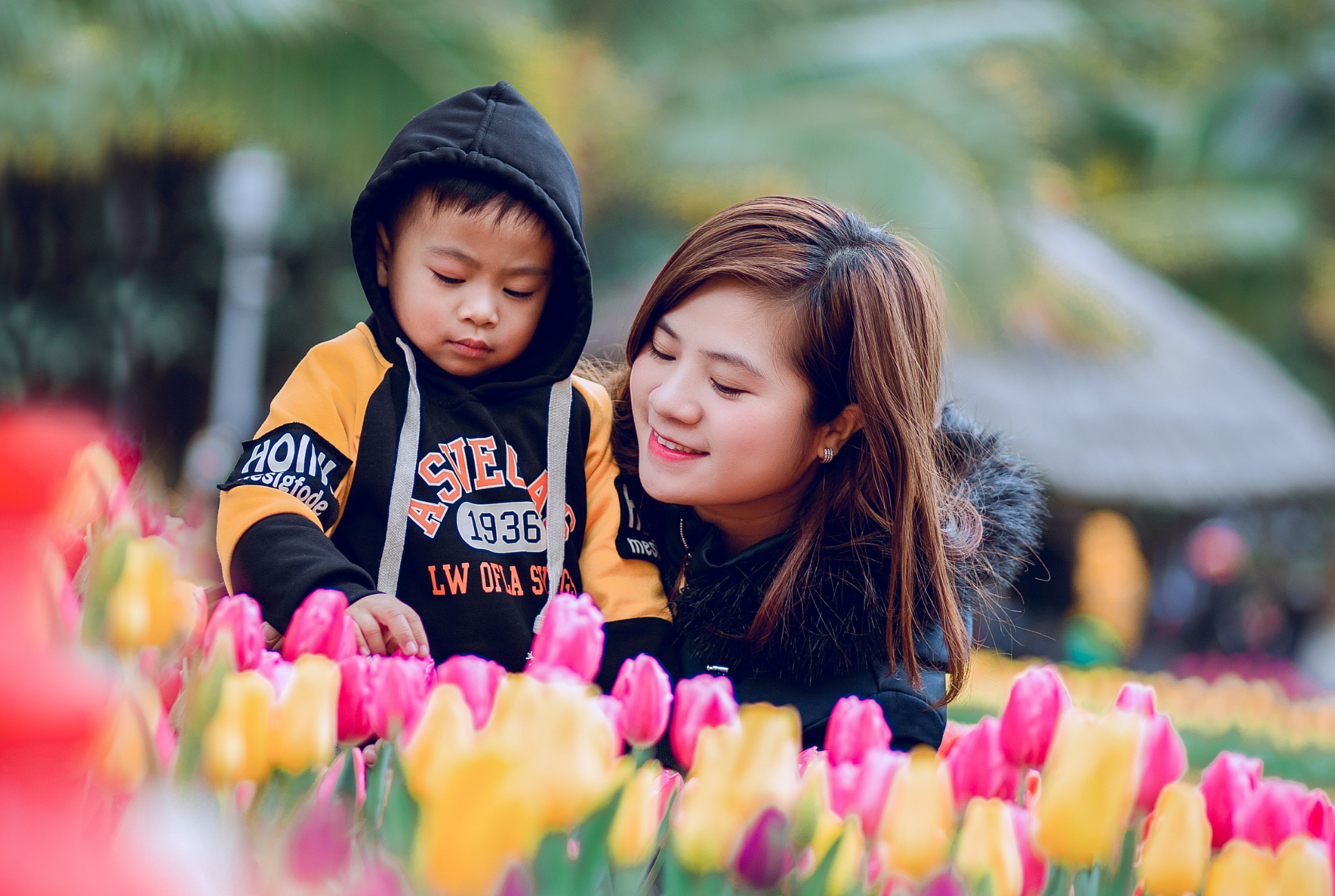 mother and son in field of spring flowers spring cleaning with kids