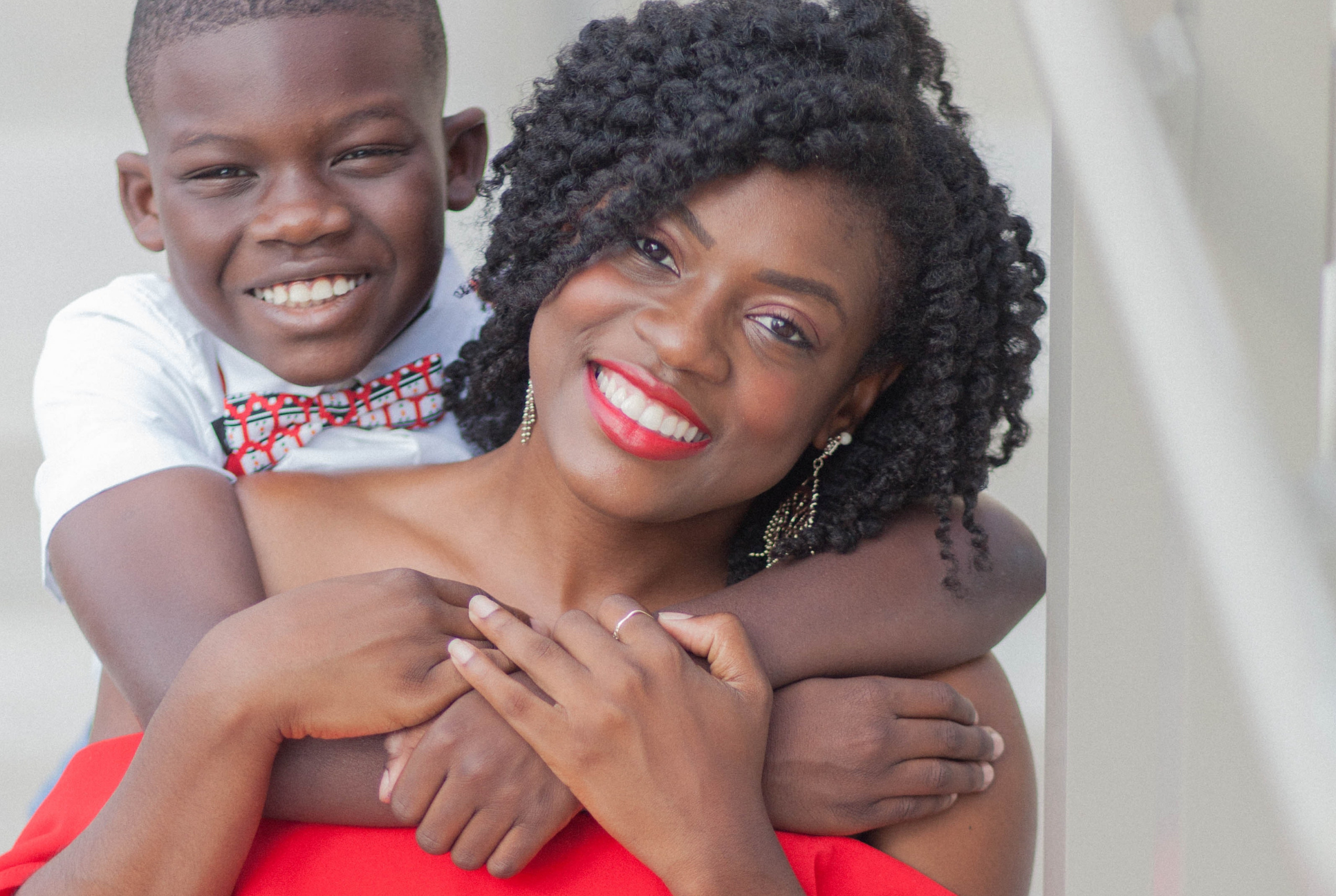 black mother and son hug and smile for camera