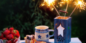 table full of red white and blue decor including sparklers