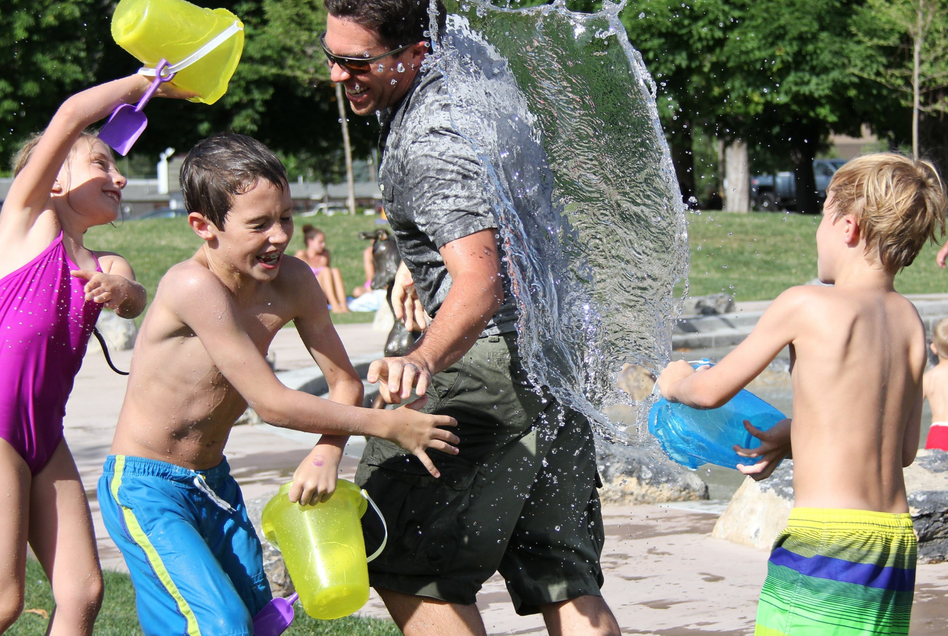 kids and adult playing with buckets of water