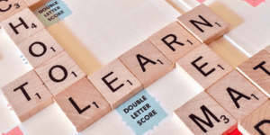 scrabble pieces spelling out school to and learn