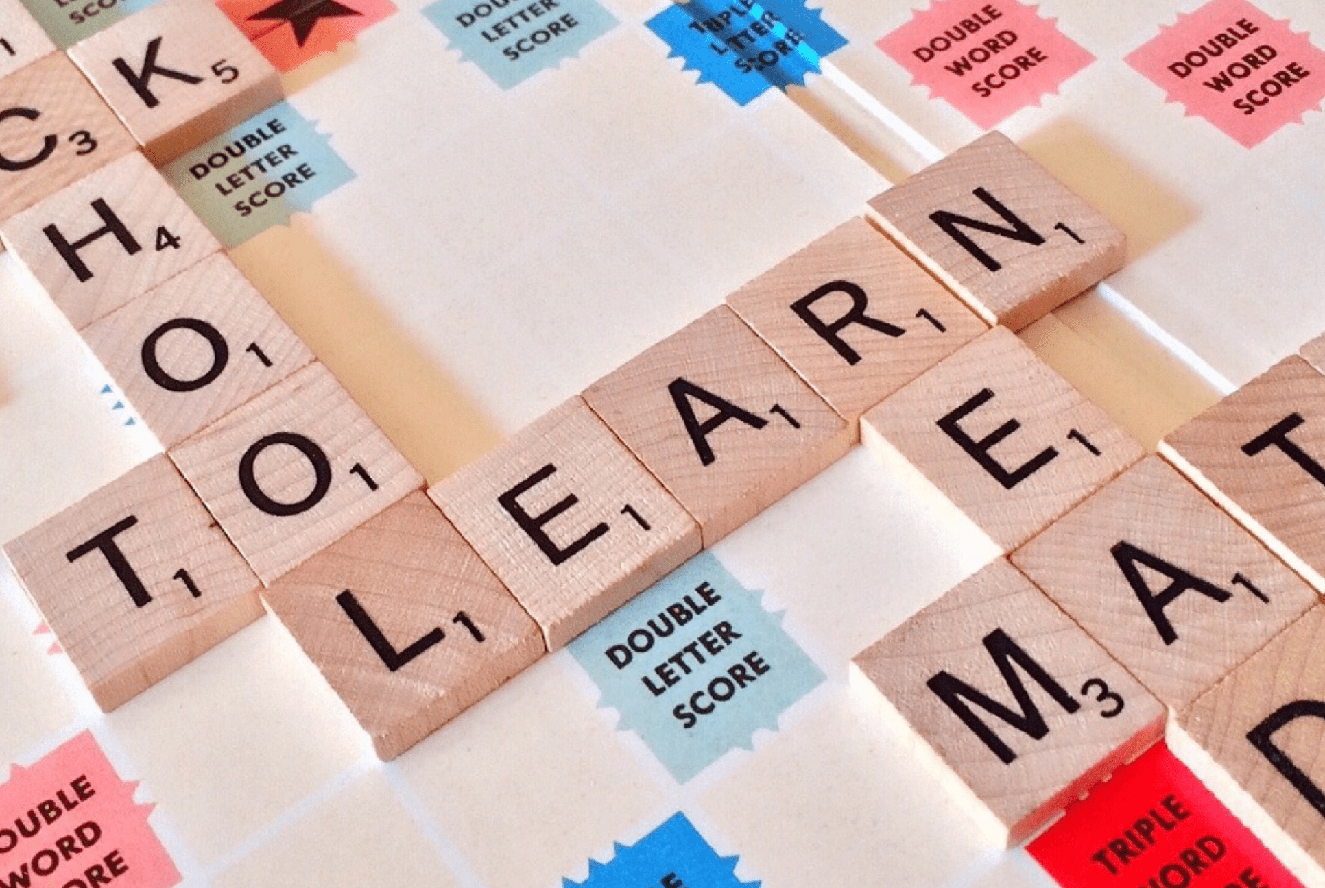 scrabble pieces spelling out school to and learn