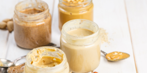 four jars of nut butters and spoon