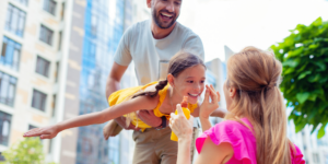 mom puts sunscreen on young girl's face