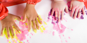 kids making handprint art with paint