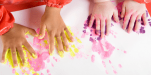 kids making handprint art with paint