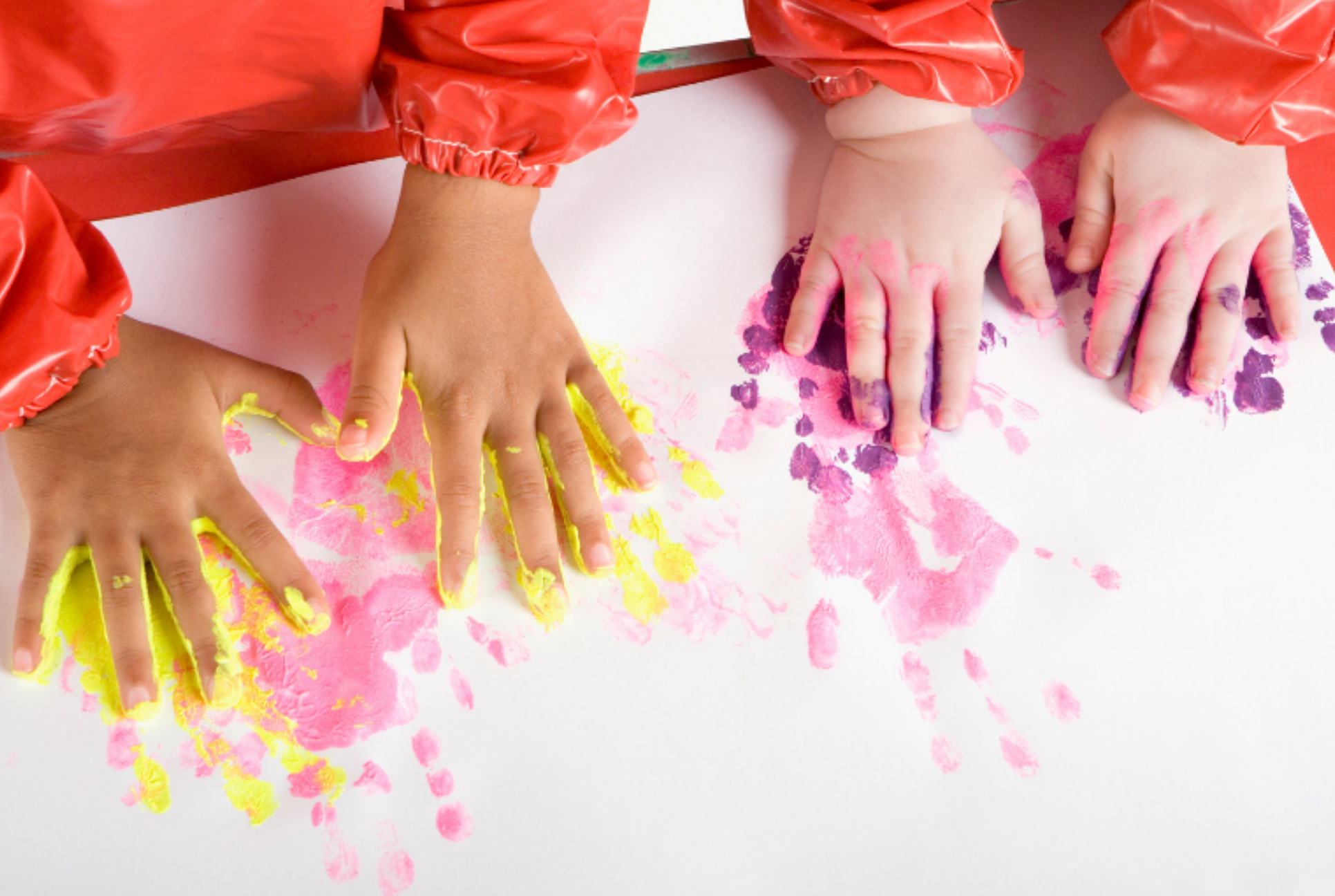 kids making handprint art with paint