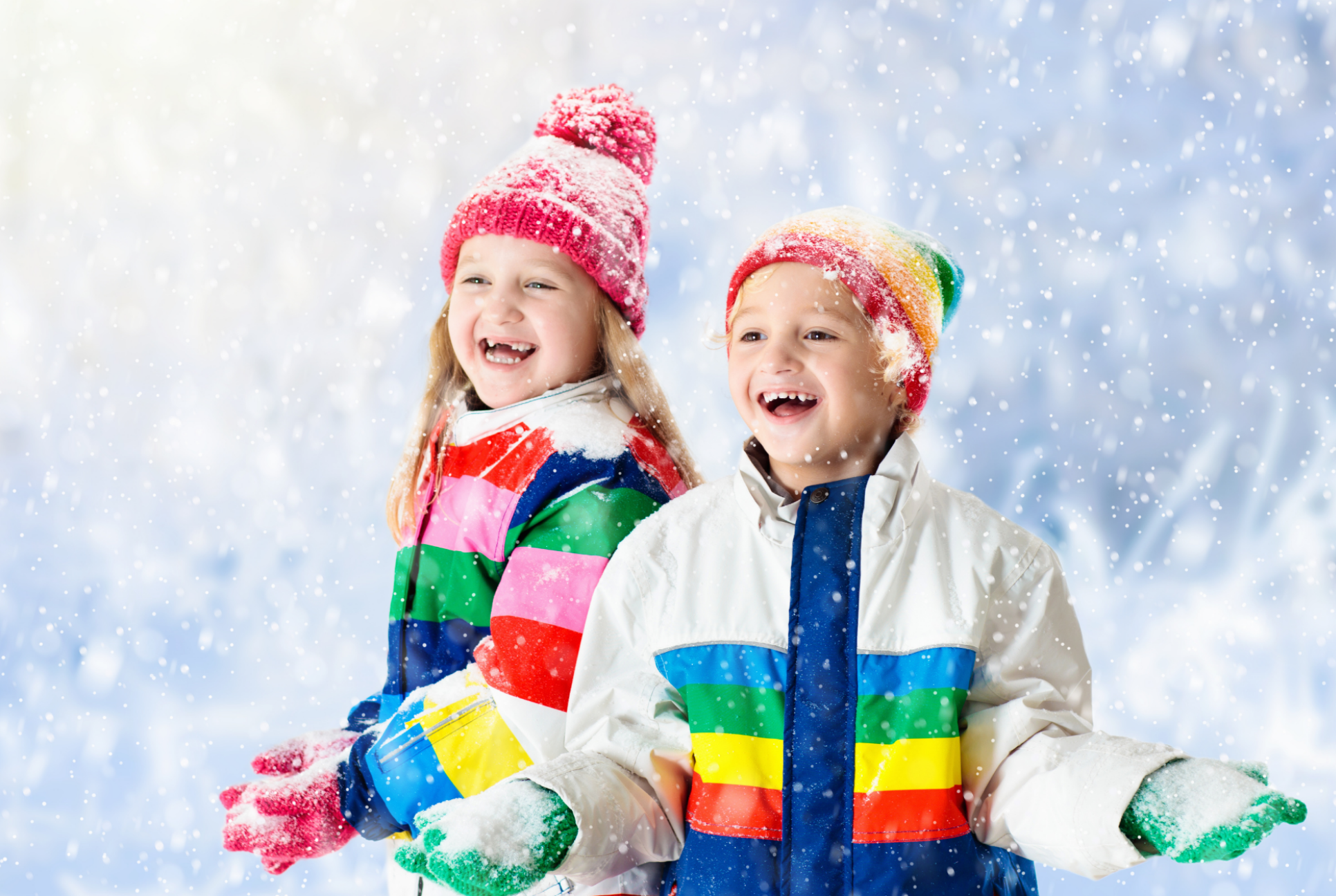 a boy and girl play in the snow
